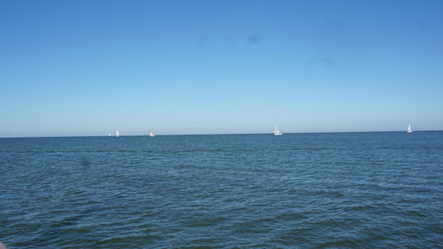 Scenic view of sea against clear blue sky