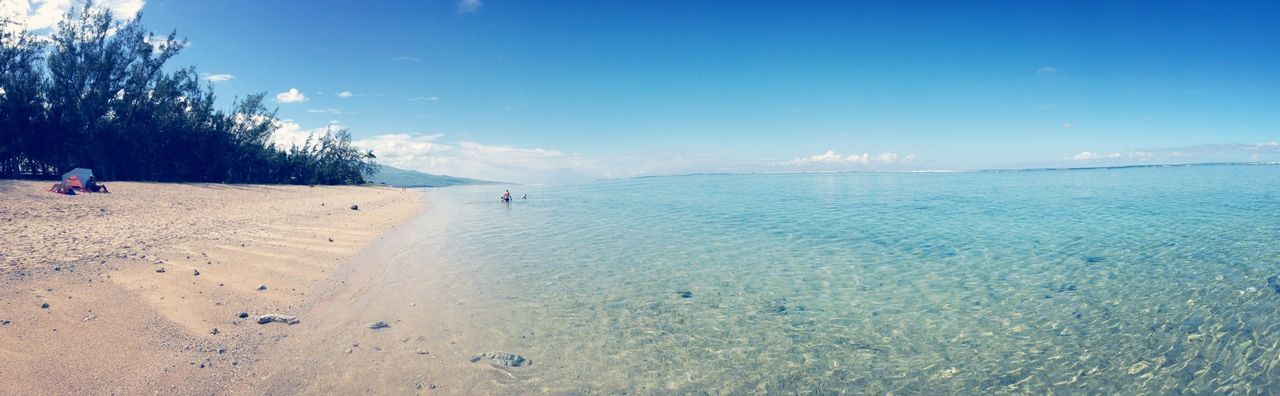 beach, water, sand, sea, shore, blue, sky, tranquil scene, scenics, tranquility, beauty in nature, vacations, incidental people, nature, leisure activity, lifestyles, day, sunlight, idyllic