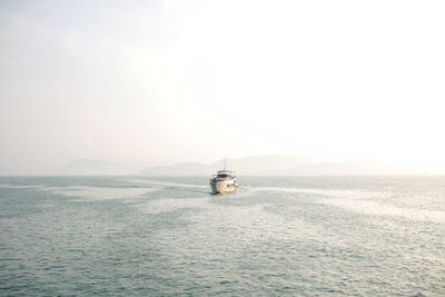 Sailboat sailing on sea against clear sky