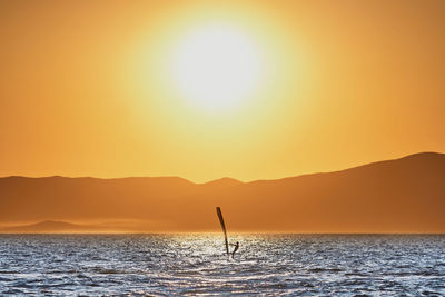 Scenic view of sea against orange sky