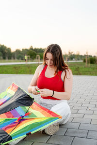 Young woman sitting outdoors