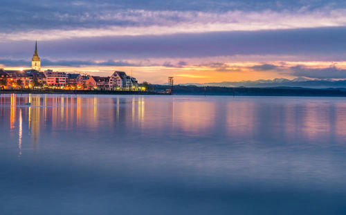 View of city at waterfront at sunset