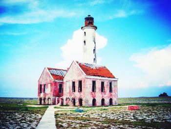 Lighthouse against cloudy sky