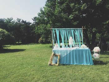 Wedding cake on table against trees in lawn