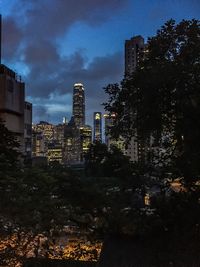 Illuminated buildings against sky at night