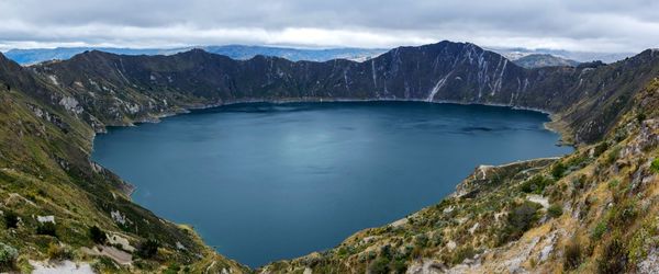 Scenic view of mountains against cloudy sky