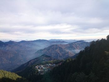 Scenic view of mountains against cloudy sky