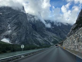 Road amidst mountains against sky