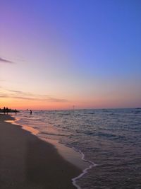 Scenic view of beach against sky during sunset