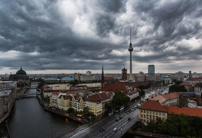 Cityscape against cloudy sky