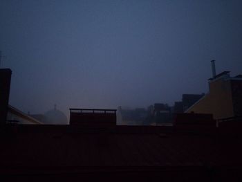 Silhouette buildings against clear sky