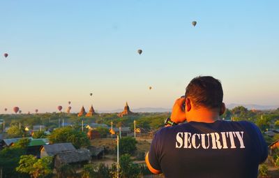 Rear view of man looking at sunset
