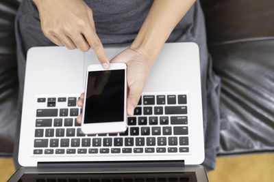 Midsection of woman using mobile phone