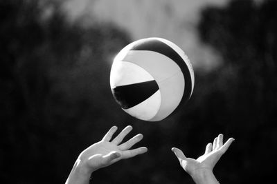 Midsection of person playing with ball against blurred background