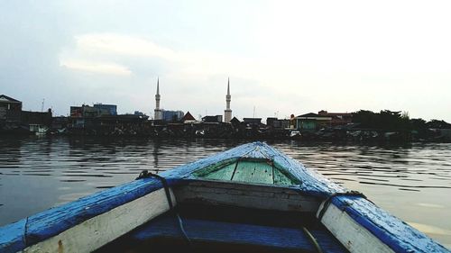 Ship in city against sky