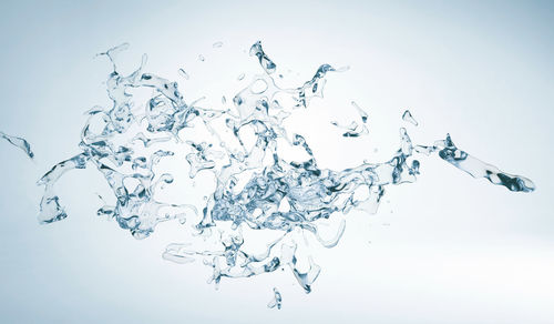 Close-up of water splashing against white background