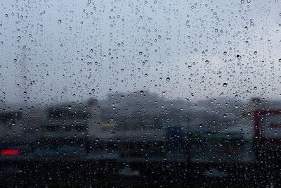 Full frame shot of raindrops on glass window