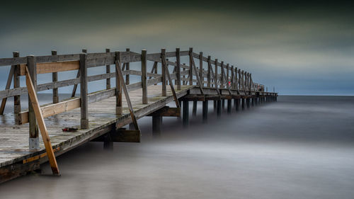 Pier over sea against sky