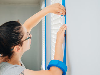 Side view of woman working at home