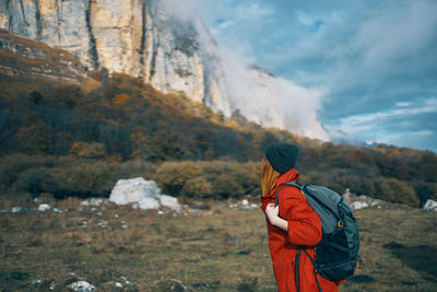 Rear view of man standing on mountain