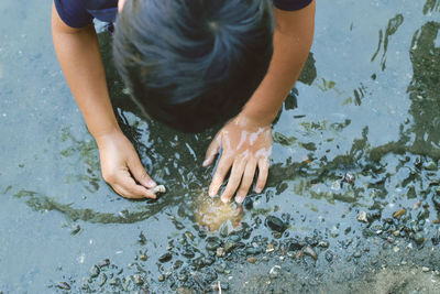 High angle view of boy playing in lake