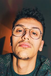 Portrait of young man wearing eyeglasses at home