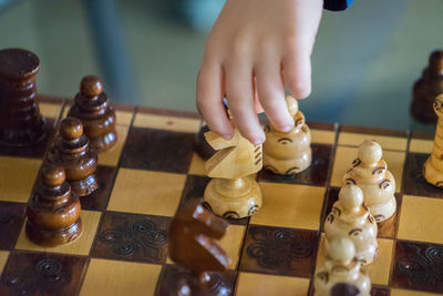 Close-up of baby playing chess at home