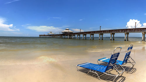 Beach chairs overlooking the fort myers pier on fort myers beach in fort myers, florida