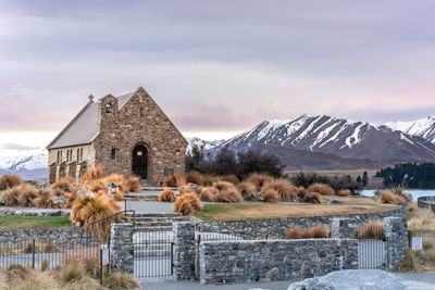 Sunrise view of the church of good shepherd with beautiful snow capped mountain range. 