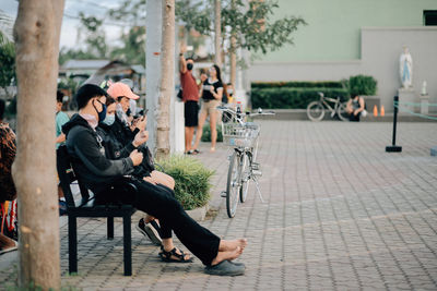 Side view of couple sitting on chair