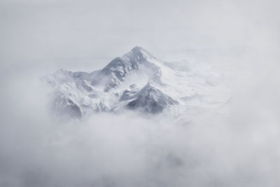 Scenic view of frozen mountain against sky