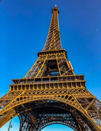 Low angle view of tower against blue sky