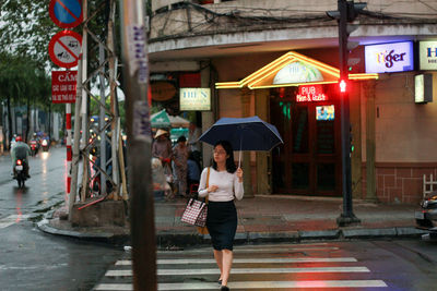 Woman standing on city street