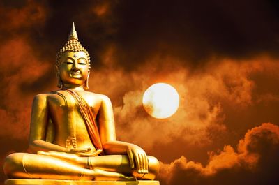 Low angle view of statue against cloudy sky