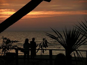 Silhouette of people at sunset