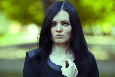 Portrait of beautiful young woman standing outdoors