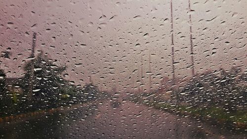 Full frame shot of wet glass window during rainy season