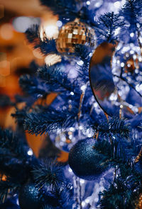 Creative blue christmas tree decorated with golden christmas balls. magic atmosphere 