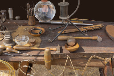 Lots of historic handcraft equipment on wooden table