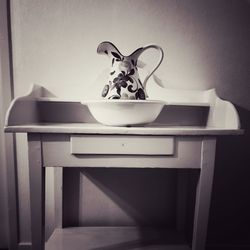 View of cat on table against wall at home