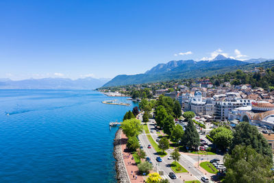 Panoramic view of city by sea against sky