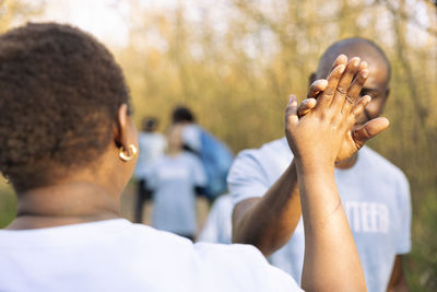 Side view of man holding hands
