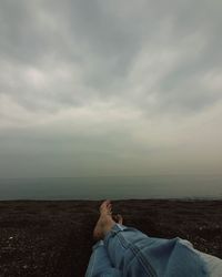 Man on sea shore against sky