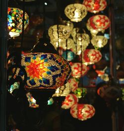 Close-up of illuminated lanterns hanging for sale