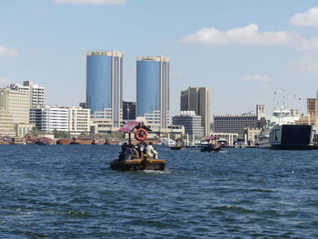 Man in sea against buildings in city