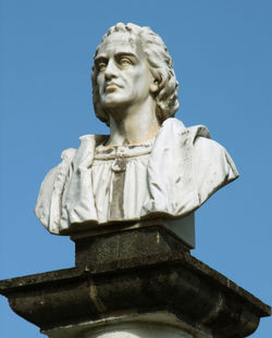 Low angle view of statue against blue sky