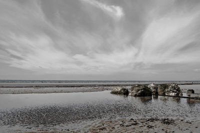 Scenic view of sea against cloudy sky