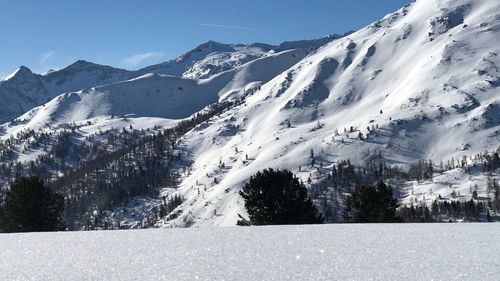 Scenic view of snowcapped mountains against sky