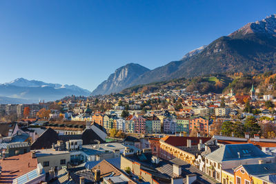 High angle view of townscape against clear blue sky and alps mountains, innsbruck, austria.