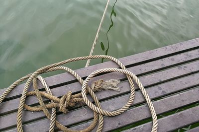 High angle view of rope tied to fishing boat at lake